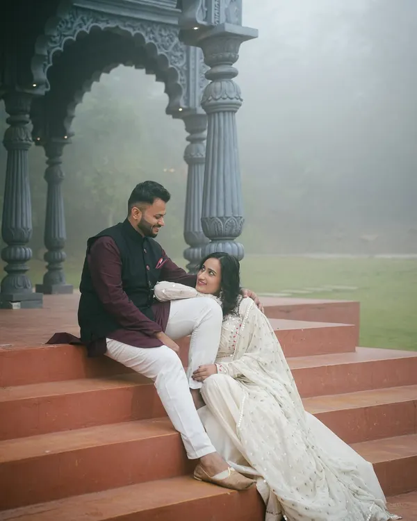 A quiet moment between a couple, framed by the ornate pillars of our studio's gazebo set. The soft, misty background creates a serene and intimate atmosphere for this pre-wedding photo.