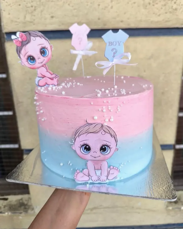 If you're not a fan of fondant but still want cute characters on your cake, edible prints are the perfect solution. This baby shower cake uses colorful cutouts on a beautiful pink and blue ombre buttercream base.