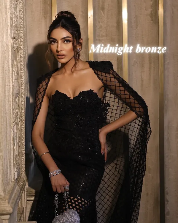 The "Midnight Bronze" look. This is the epitome of evening sophistication, featuring mesmerizing bronzed eyes, flushed nude-pink lips, and a chic top knot bun.