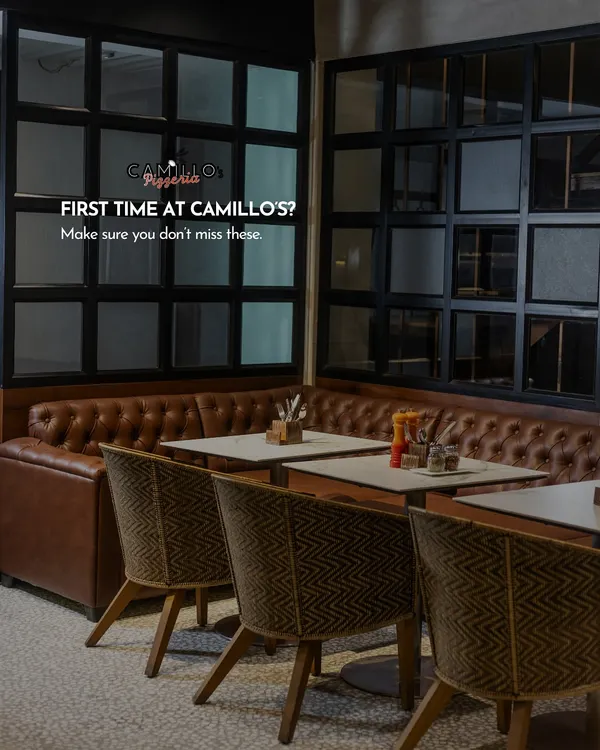 A view of our cozy indoor seating area, with comfortable leather booths and warm lighting. It’s a welcoming space designed for lingering conversations and memorable meals.
