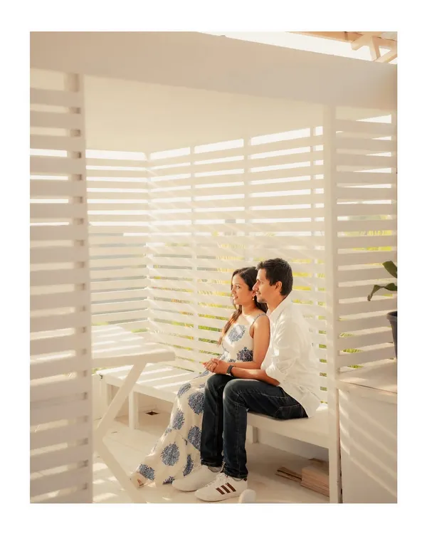Annalisa and John in a bright, white cabana. The slatted walls create beautiful light and shadow patterns, adding geometric interest to this modern couple portrait.