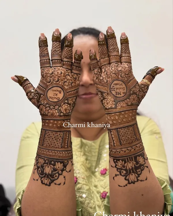 A beautiful, full-coverage bridal mehendi with the classic Hindi phrase "Dulhe ki Dulhan" (Groom's Bride) written in the center. The design is packed with intricate traditional patterns.