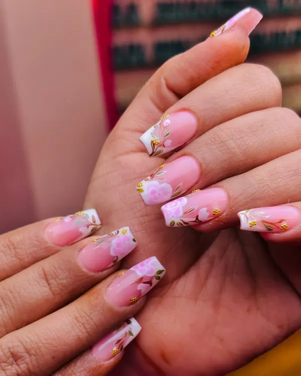 A classic pink and white French manicure gets a beautiful upgrade with delicate, hand-painted pink flowers and gold leaf accents. This is elegance in full bloom.