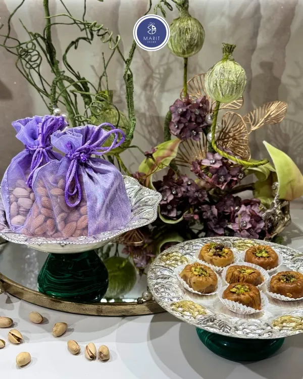 I designed the Emerald Glow-Bowl and Gulzar Platter to bring grace to every occasion. The silver platter with its intricate base is perfect for serving sweets, while the bowl is ideal for dry fruits.