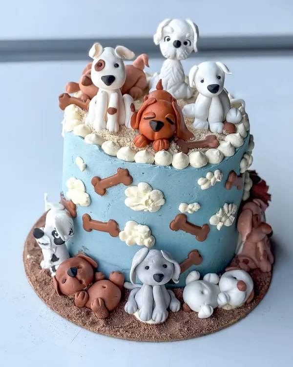 This cake is for all the dog lovers out there! It was one of my favorite projects, handcrafting each of these unique puppy figurines out of fondant to surround a light blue buttercream cake. I love creating these kinds of highly personalized animal-themed cakes.