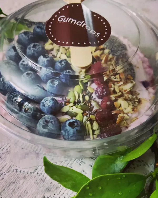 A healthy and delicious start to your day with our berry smoothie bowl, packed with fresh blueberries, nuts, seeds, and cranberries.