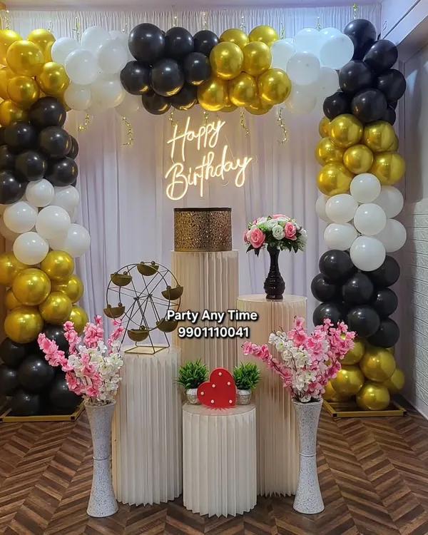 A classic black, white, and gold balloon arch setup in my Kanakapura party hall, complete with plinths and a neon sign. This package is available at a great price.