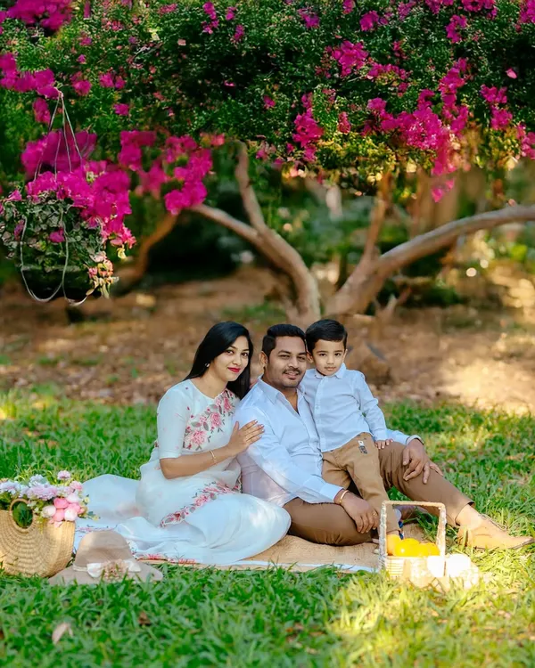 We begin our outdoor sessions by creating a comfortable, classic family portrait. Seated on a picnic blanket under a flowering tree, this family’s coordinated outfits and relaxed smiles set a warm and inviting tone for the entire shoot.