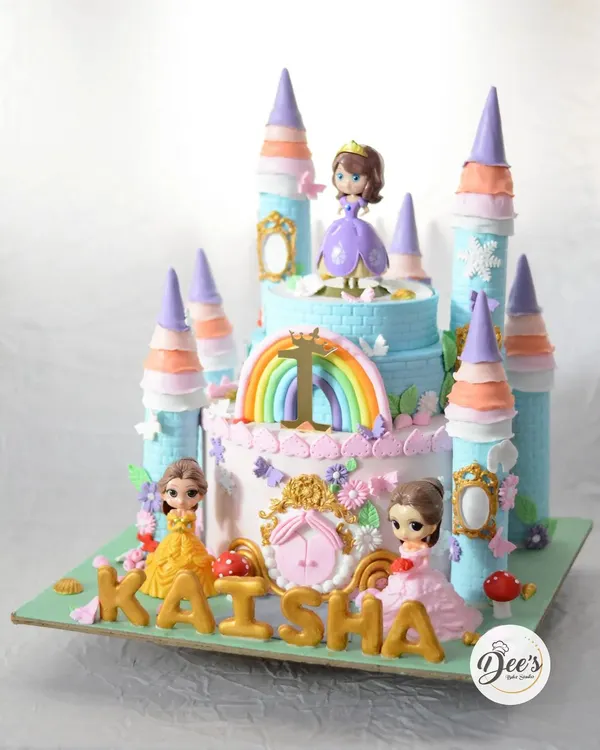 A princess castle cake fit for royalty. This grand, multi-tiered creation features towers, rainbows, and beloved princess figurines, making it the ultimate centerpiece for a fairytale birthday party.