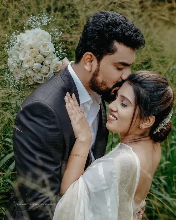 A gentle kiss on the forehead, a promise of forever. We believe in capturing the quiet, tender moments that define your love story. This is the soul of our wedding photography.
