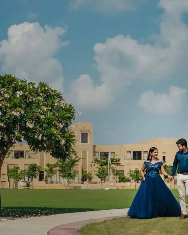 Our navy blue ball gown is a sophisticated choice for a pre-wedding shoot. The rich color and classic silhouette look stunning against the lush green and bright blue sky of this beautiful location.
