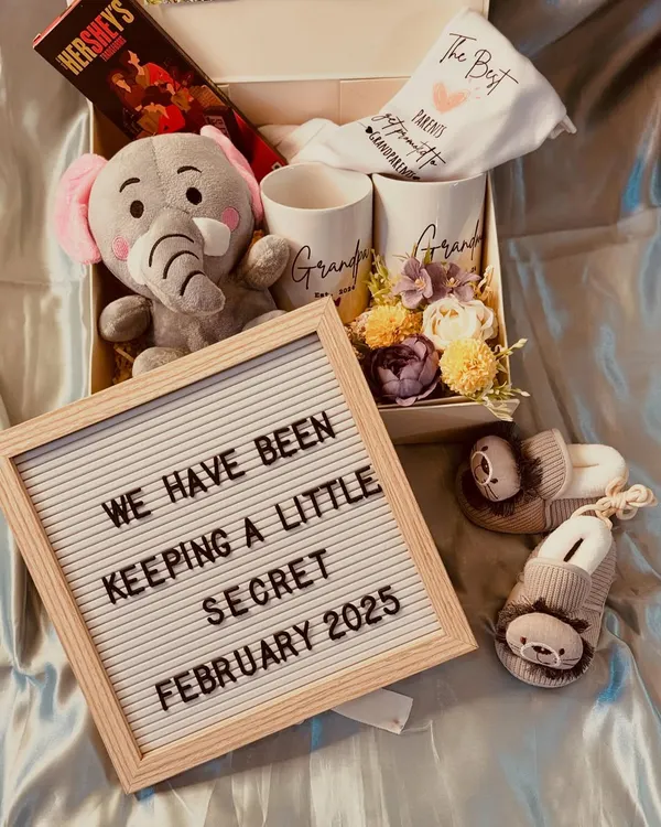This pregnancy announcement hamper is such a sweet way to share your secret. It includes a letterboard, "grandparents" mugs, a soft toy, and adorable baby booties.