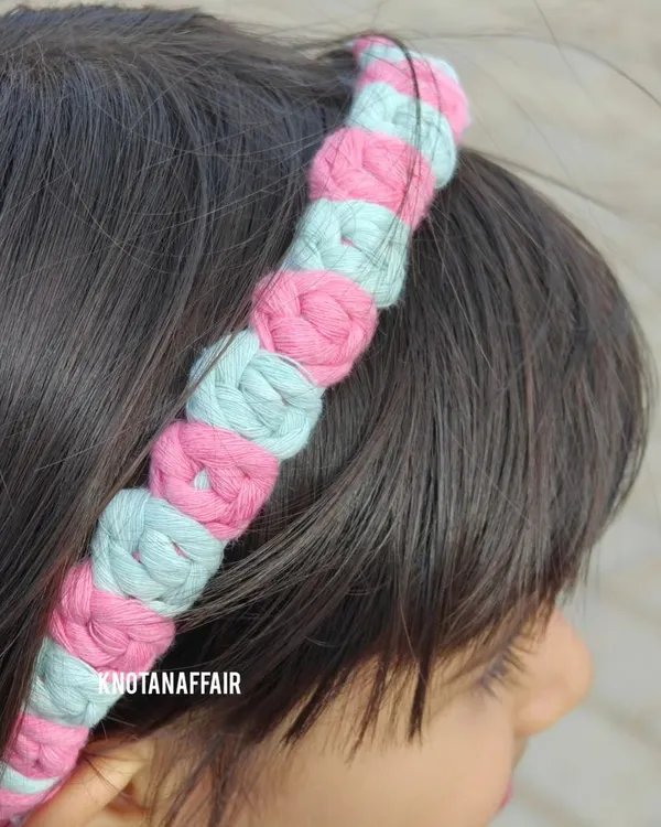 A close-up of my macrame rose flower hairband, worn by a happy little customer. This two-tone pink and mint design is stylish, comfortable, and perfect for both casual and special occasions.