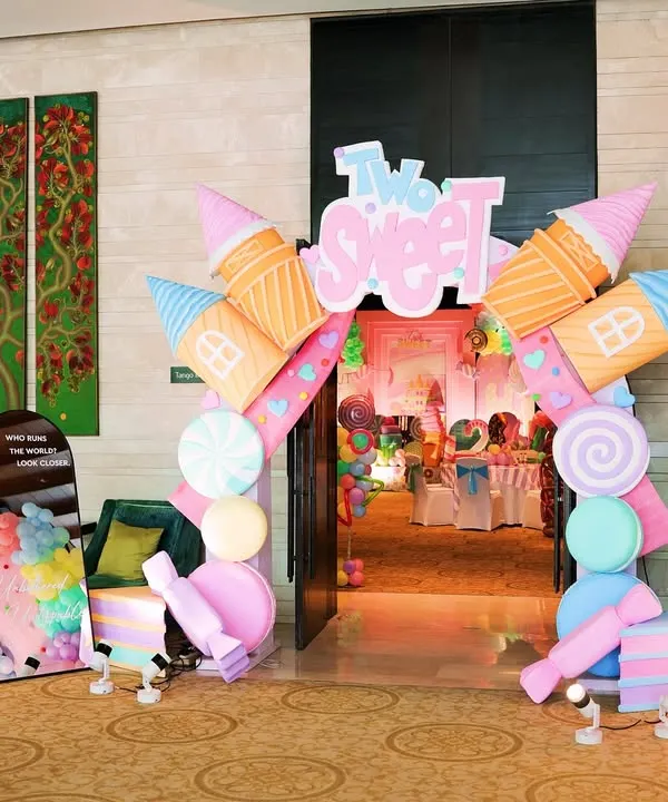 The grand entrance to a "Two Sweet" Candyland party. I used giant ice cream cone and candy props to build an archway, immediately immersing guests in the theme.