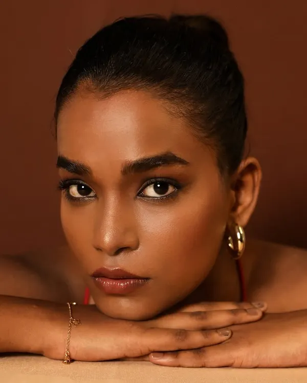 This is what I mean by 'unreal skin'. This unretouched close-up shows a seamless, glowing finish on deep skin, achieved through careful layering and blending, not heavy foundation.