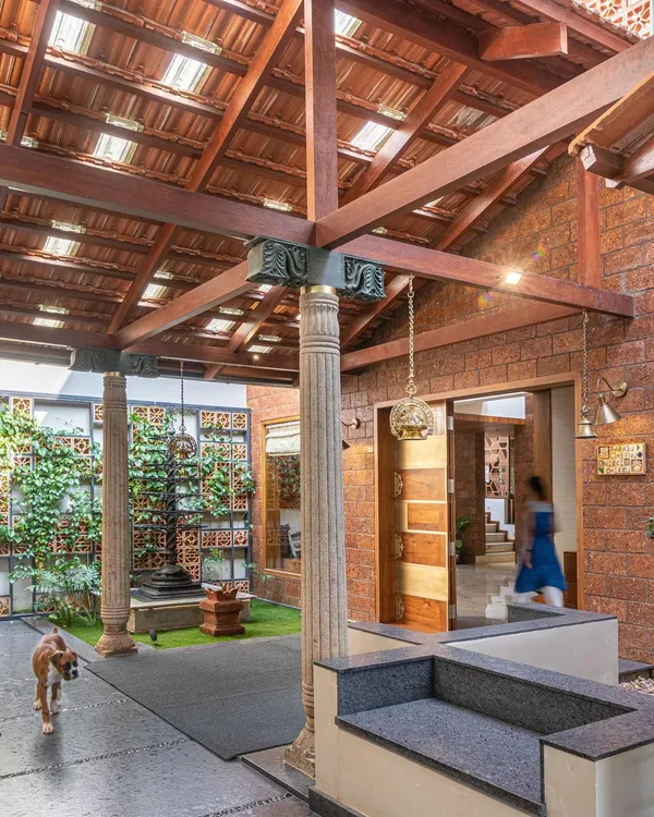 A traditional Indian courtyard concept, reimagined. We used reclaimed stone pillars and a vertical garden wall to create a grand, green entrance that feels both rustic and deeply connected to nature.