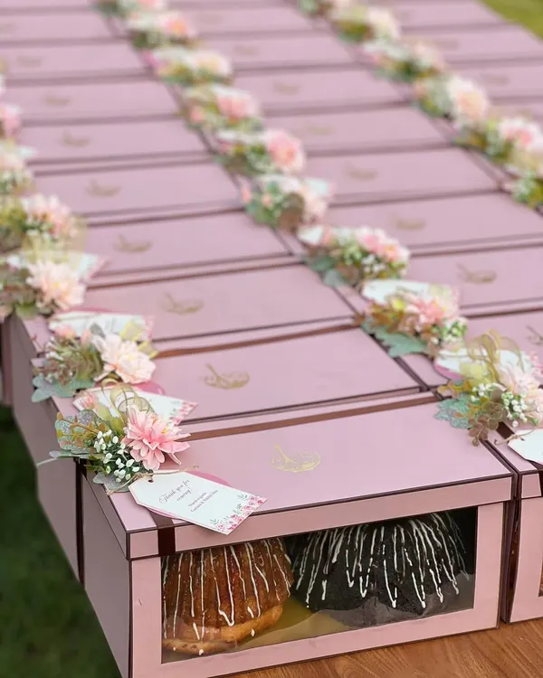 We believe in doubling the delight, which is why our twin bundt cake sets are a favourite for event return favours. This large order, prepared for a special celebration, features our signature cakes packaged in elegant pink boxes, each adorned with custom floral arrangements and personalised tags.