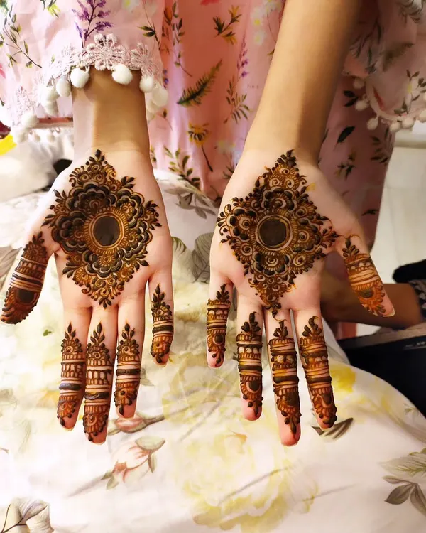 A classic party design featuring a central mandala on the palm with detailed patterns on the fingers.