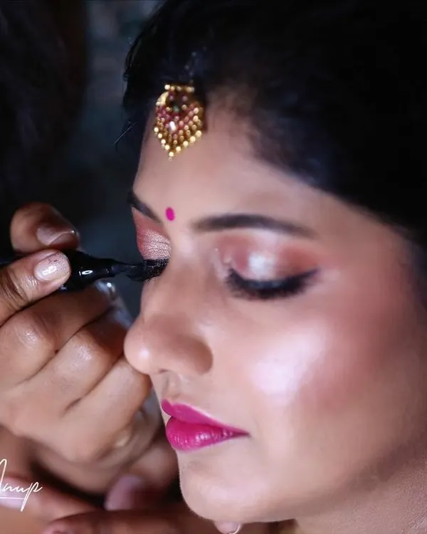 A behind-the-scenes moment showing the precision of eyeliner application. A sharp, clean wing is a key element for many of my bridal looks, defining the eyes beautifully for the camera.