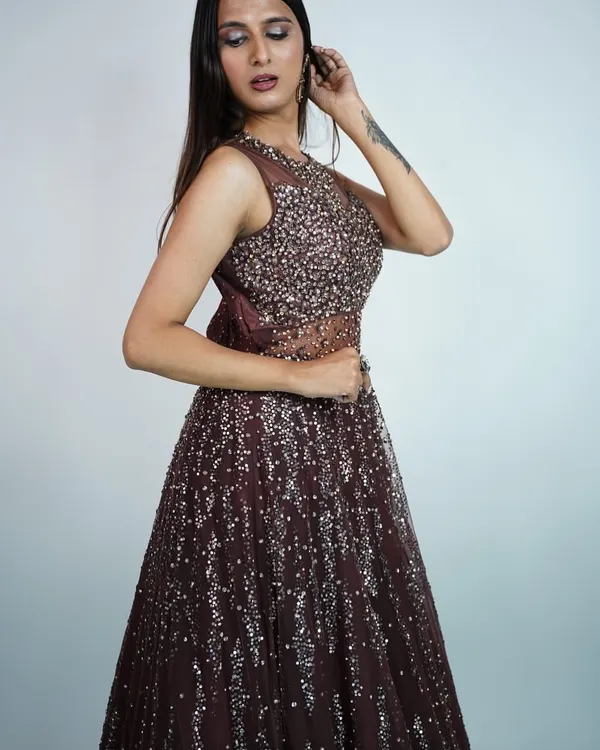 This deep brown sequined gown is perfect for an evening reception or cocktail party. The sheer neckline adds a touch of allure.