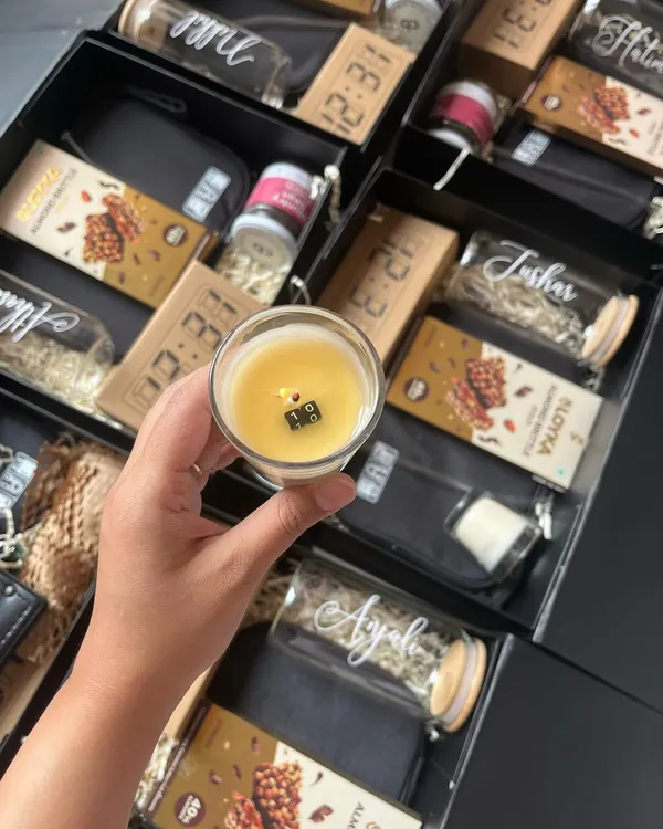 I had the honor of curating these bespoke 10th-anniversary gift hampers for Bloomberg. This image shows a personalized candle with a hidden message, one of ten items in the box.