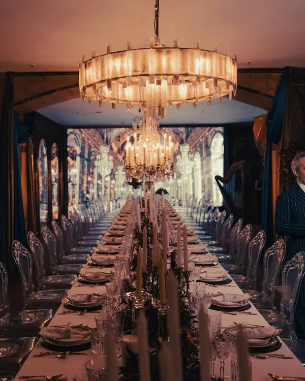 We transformed a space into an ode to the Hall of Mirrors at Versailles. This grand, candlelit tablescape, set under magnificent chandeliers, shows how we create fully immersive worlds for our clients, making every guest feel like royalty.