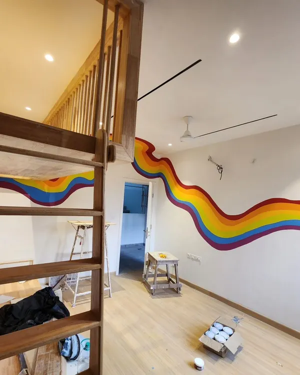 We created this flowing rainbow mural for a child's bedroom, designed to wrap around the room and connect the lower level with the wooden loft bed.