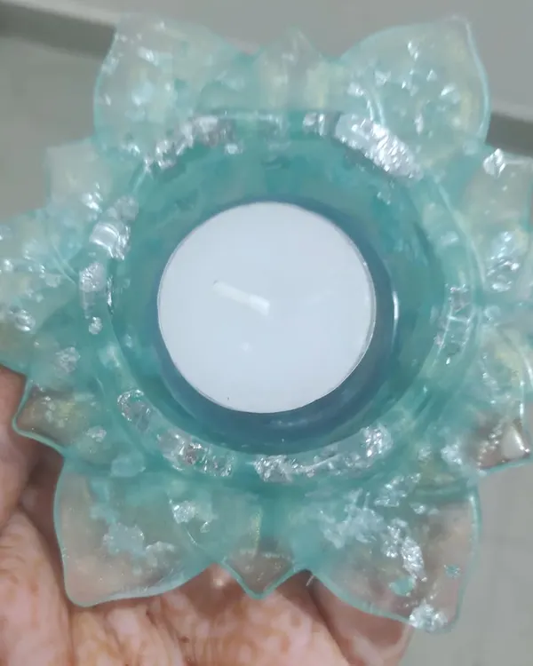 This hand-held view shows the delicate beauty of my resin T-light holders. This one is made with a light blue resin and sparkling silver flakes, creating a lovely effect when lit. These are a popular choice for elegant wedding return gifts.