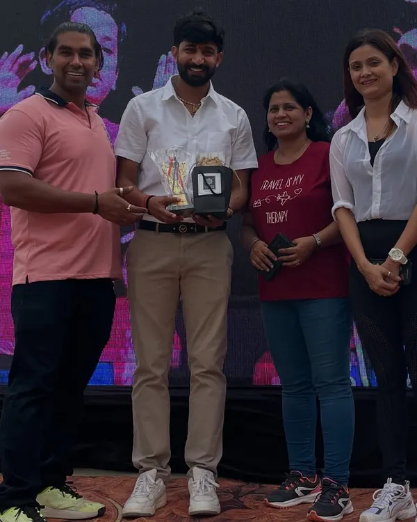 Receiving an award for my contribution to a family fitness event. It is an honor to be recognized for my work in promoting a healthy lifestyle.