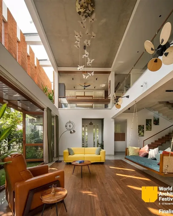 This is the heart of my 'House of Greens' project, a space designed to feel open, airy, and connected to the outdoors. The double-height living area is flooded with natural light from a large skylight, illuminating the warm wood floors and the custom butterfly art installation. This project was a finalist at the prestigious World Architecture Festival 2024.