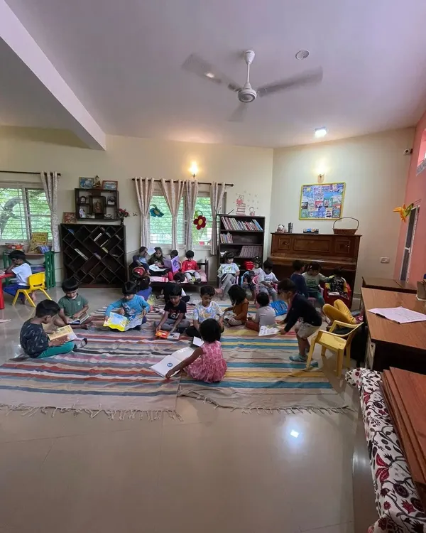 A wide view of our library during a silent reading session. Children are scattered around the room, each lost in their own book, creating a peaceful and studious atmosphere.
