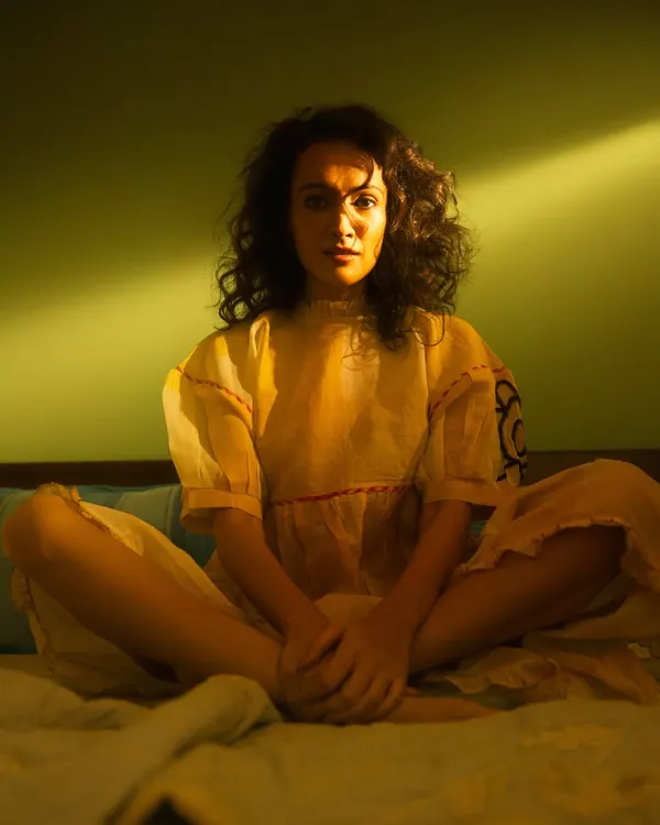 Here, I played with a single beam of light to create a cinematic, intimate portrait of Dipannita Sharma. The sharp contrast between the artificial sunbeam and the deep shadows crafts a mood of quiet contemplation, turning a simple moment into a story.