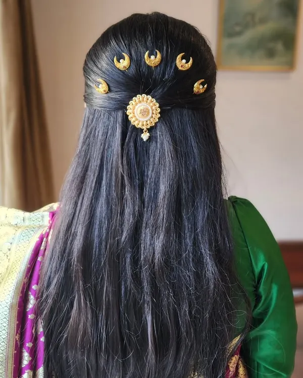 A unique and elegant hairstyle featuring traditional half-moon shaped "chandrakor" hairpins, perfect for a classic Marathi look.