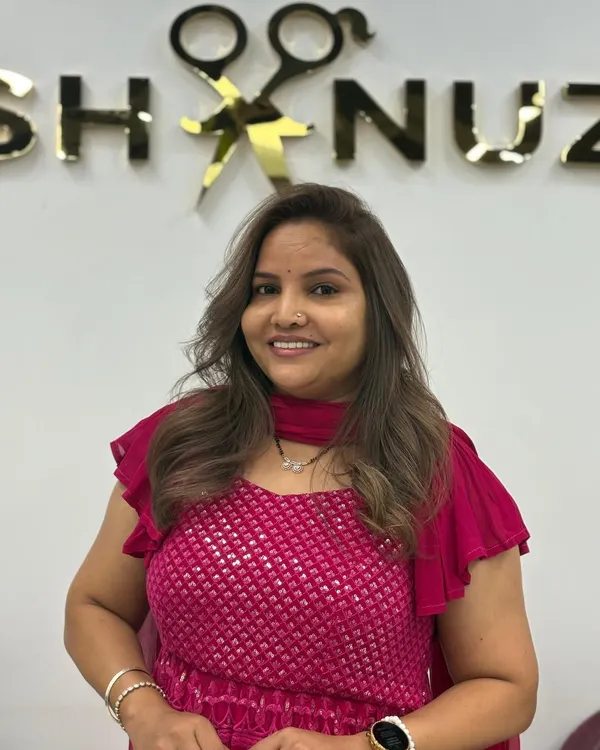 A beautiful, happy client showing off her new highlights and toned color. Her smile is the perfect accessory.