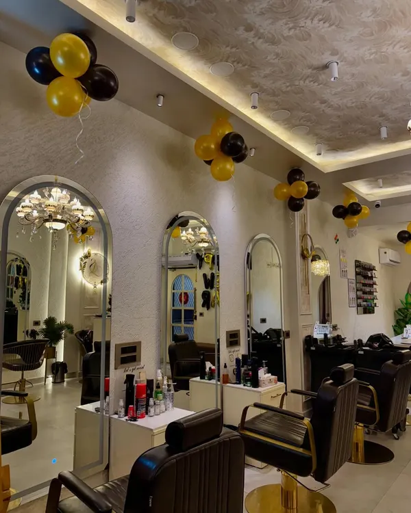 A view of our main salon floor, featuring modern styling chairs, large arched mirrors, and elegant decor. We keep the space bright and clean to provide a luxurious and comfortable environment for all our clients.
