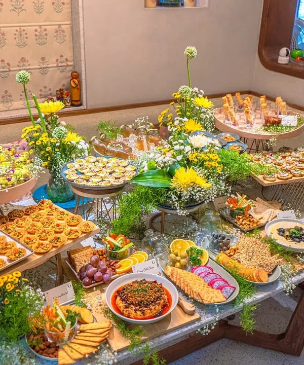 A vibrant and abundant grazing table, beautifully styled for a festive Ganesh Chaturthi celebration. This spread showcases a variety of our gourmet appetizers, dips, and fresh floral arrangements, representing our signature artful presentation.