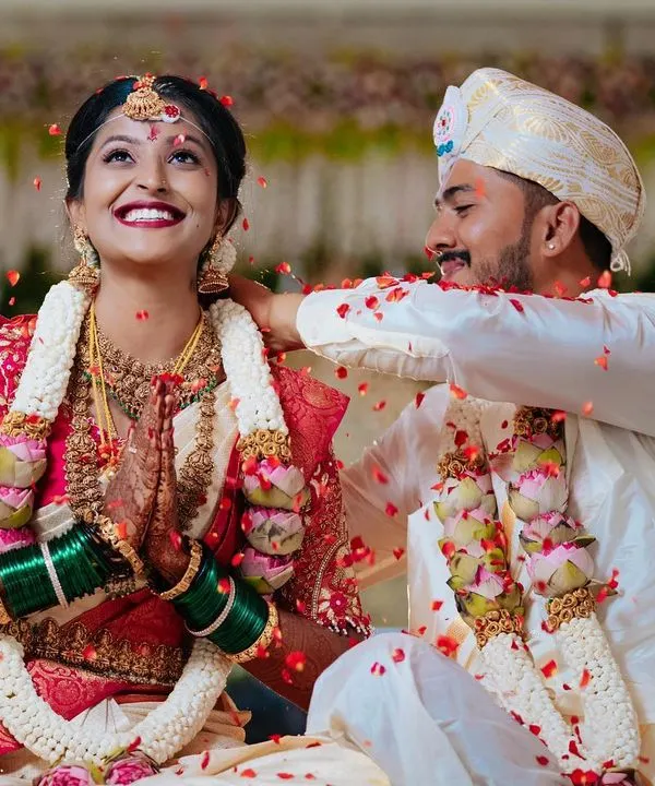 The sacred moment of the Mangalya Dharanam, where the groom ties the holy thread around the bride's neck. The shower of petals and the bride's joyful smile make this a truly cherished memory.