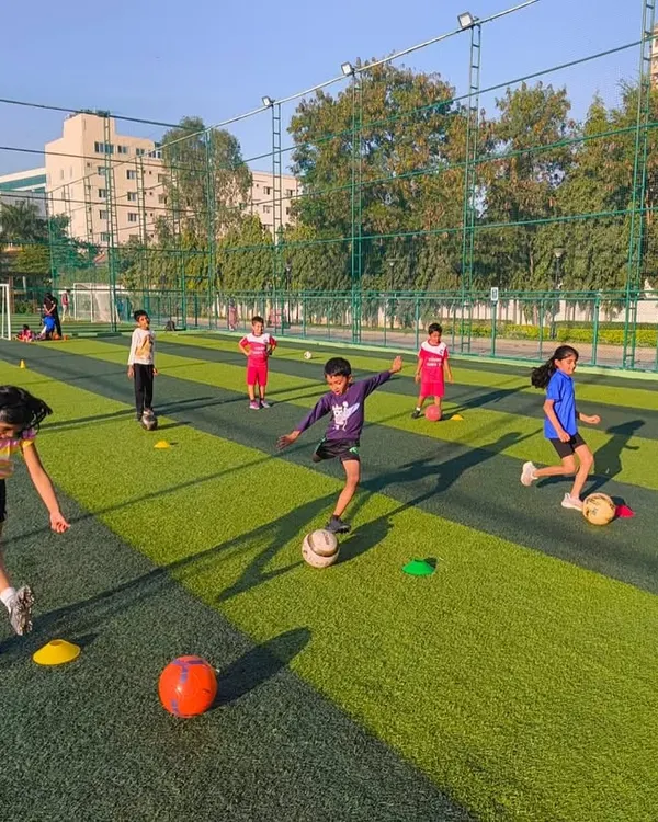 This is what it's all about! We create a dynamic and fun environment where kids can run, play, and fall in love with football. This action shot from one of our turf classes shows our young players developing their dribbling skills and game awareness.
