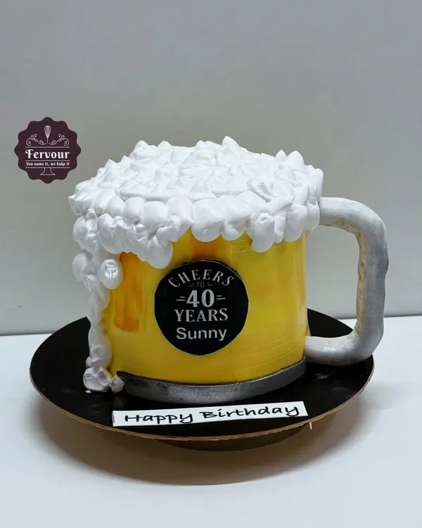 A fun 3D beer mug cake, perfect for a 40th birthday toast. The entire mug is a carved cake, and the frothy foam on top is made from piped whipped cream.