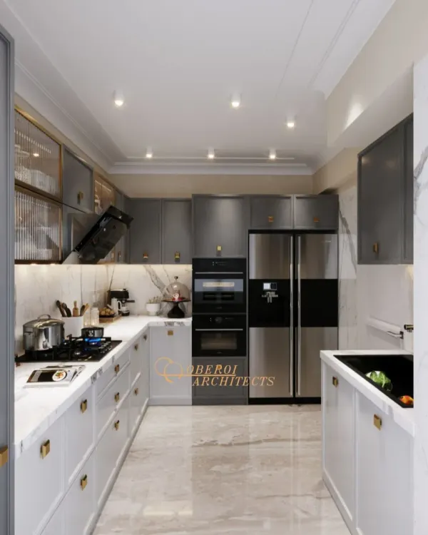 This U-shaped kitchen is a model of efficiency and style. We used a two-tone scheme with white and grey cabinets, complemented by a marble backsplash and floor. All appliances are seamlessly integrated for a clean, modern look.