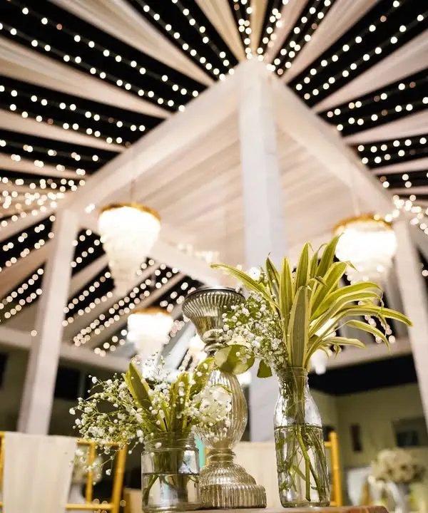 A stunning shot of the wedding decor at a destination wedding in Ranthambore. The canopy of fairy lights creates a magical, starry night effect for the celebration.