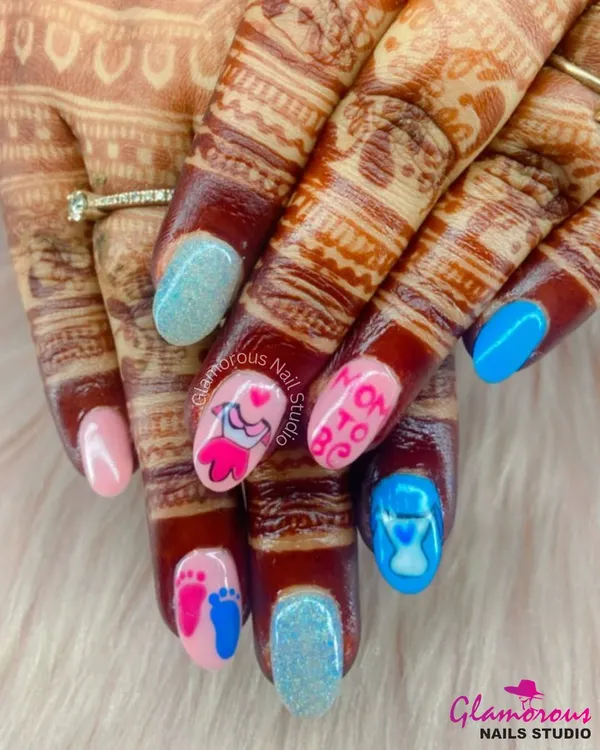 The perfect manicure for a mom-to-be. This adorable set features "Mom to Be" text, baby footprints, an hourglass, and a baby dress, all hand-painted in pink and blue.