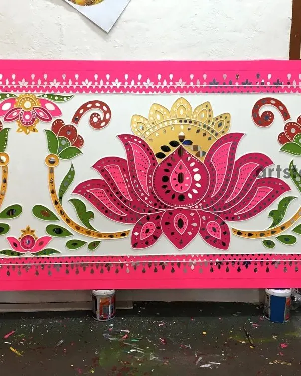 A completed Lippan art panel featuring a vibrant lotus motif. This traditional mud and mirror art form, which we create on boards for installation, is decorated with hundreds of hand-placed mirrors that catch the light beautifully.