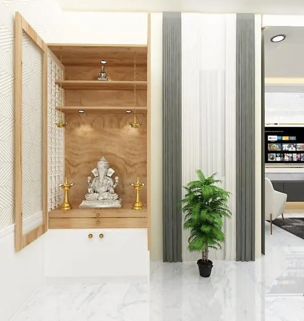 A beautifully crafted pooja unit with a wooden finish and cabinet doors. The design is modern yet reverent, providing a dedicated space for prayer and reflection within the home.