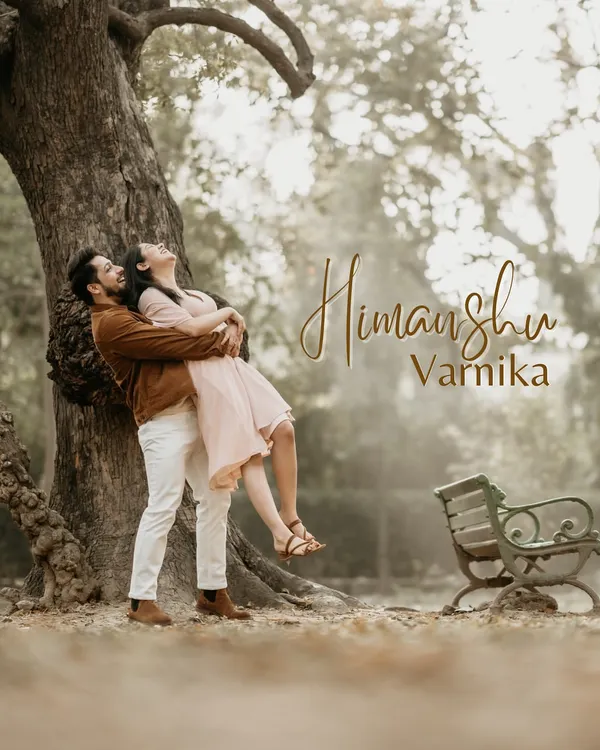 A playful and romantic lift under a beautiful old tree in a park. This image is full of life and joy, capturing the fun side of a couple's relationship during a golden hour shoot.