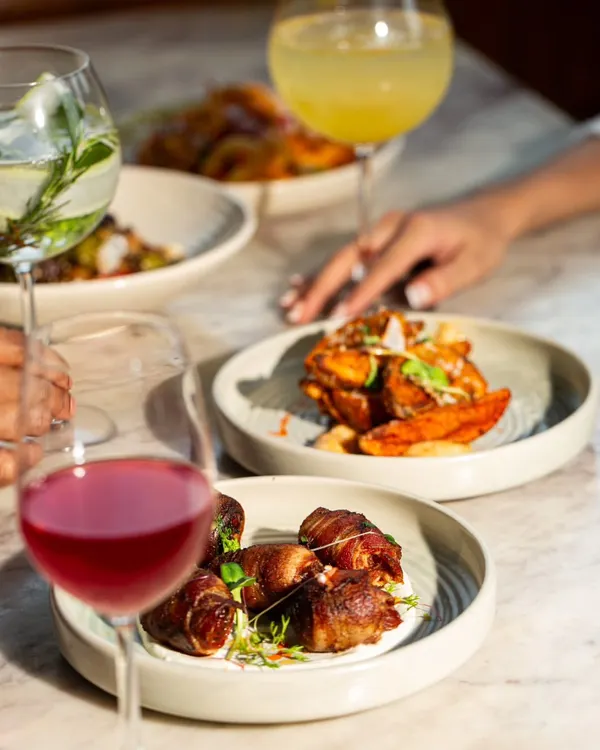 It's a flavor fiesta during my Apero Hour. Indulge in my tapas menu, featuring bites like chorizo-filled dates wrapped in bacon and crispy potato wedges.