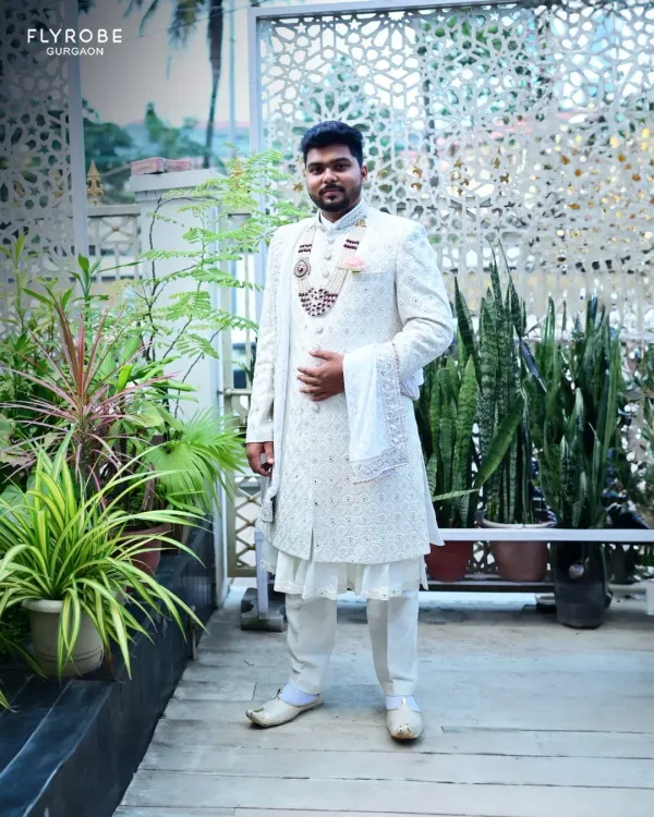 Here is a full-length view of one of my most popular rentals, an all-white sherwani with intricate self-embroidery. It’s a timeless and elegant choice for any groom.