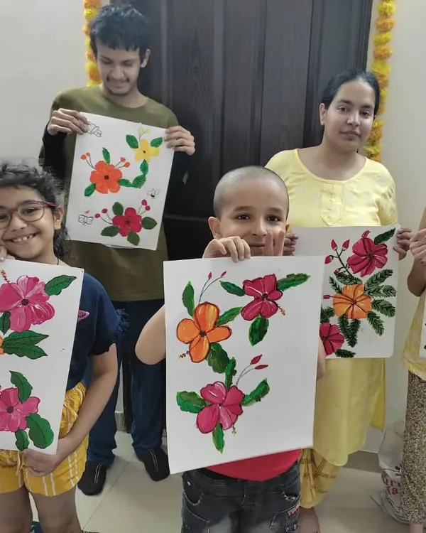 A group of proud artists from Day 1 of our art camp. They just finished their beautiful hibiscus flower paintings, each one a unique expression of what they learned about color mixing and brush strokes.