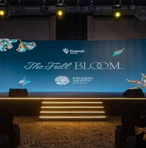 The main stage for the Piramal Realty 'The Full Bloom' event, designed to be both elegant and commanding. The curved LED screen and tiered platform created a focal point that was visible and impressive from every seat.