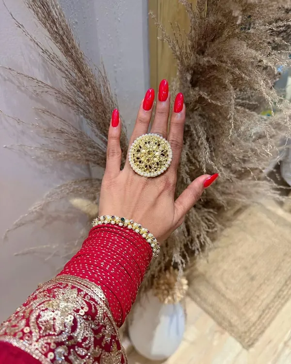 Getting into the Diwali spirit with these bold and beautiful red nails. Paired with traditional jewelry, this classic red manicure is the perfect accessory for the festival of lights.